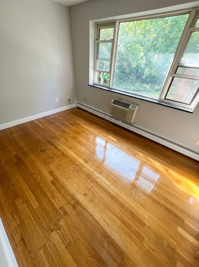 Same hardwood floor after refinishing: sanded, stained, and finished